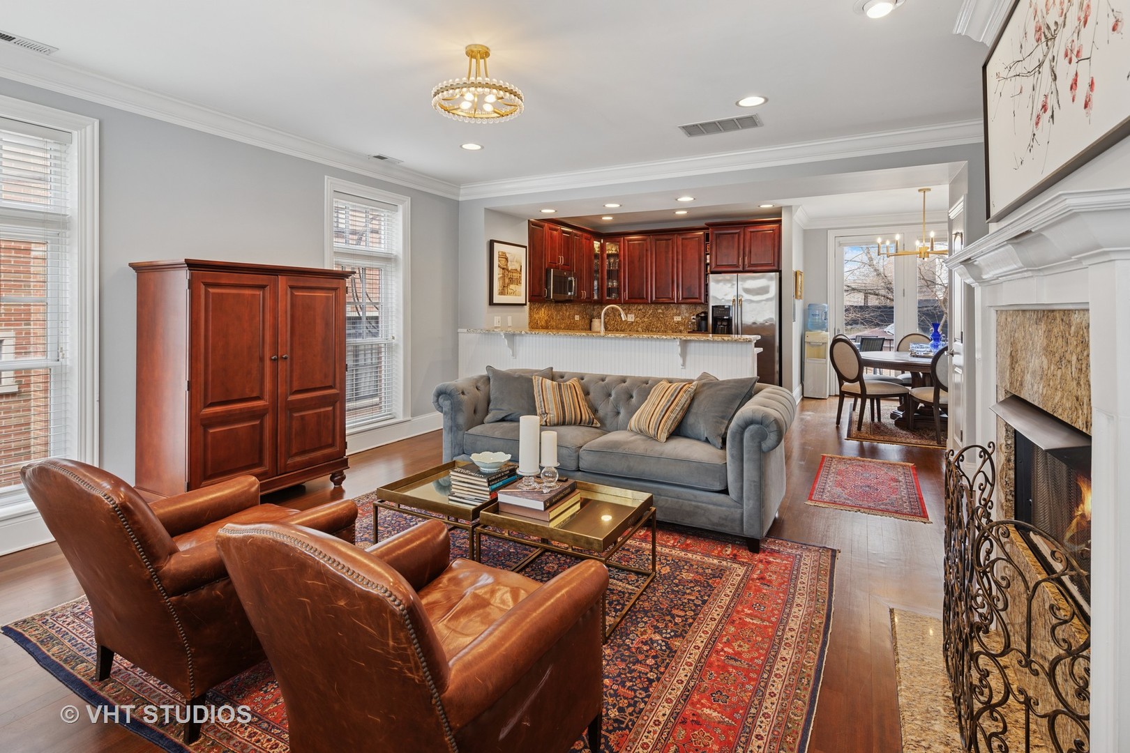 1608 West Grace Street Chicago, IL 60613 - Photo 4 of 25 a living room with furniture a dining table and a fireplace