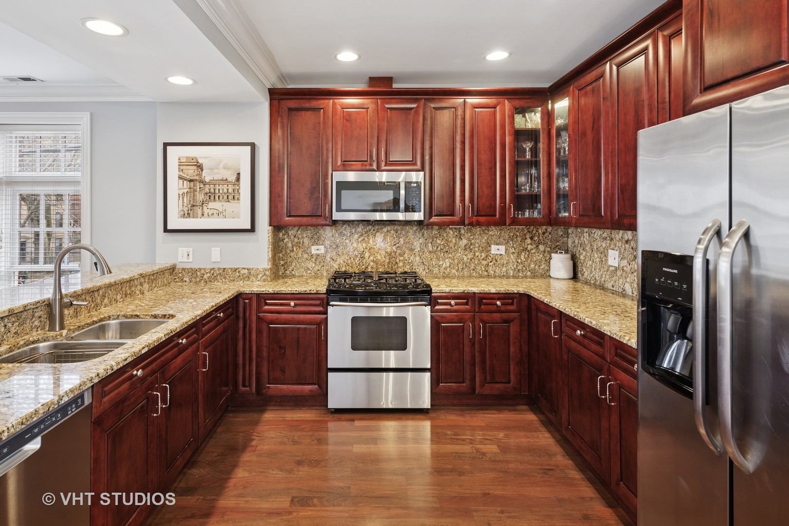 1608 West Grace Street Chicago, IL 60613 - Photo 6 of 25 a kitchen with stainless steel appliances granite countertop a stove top oven a sink and dishwasher
