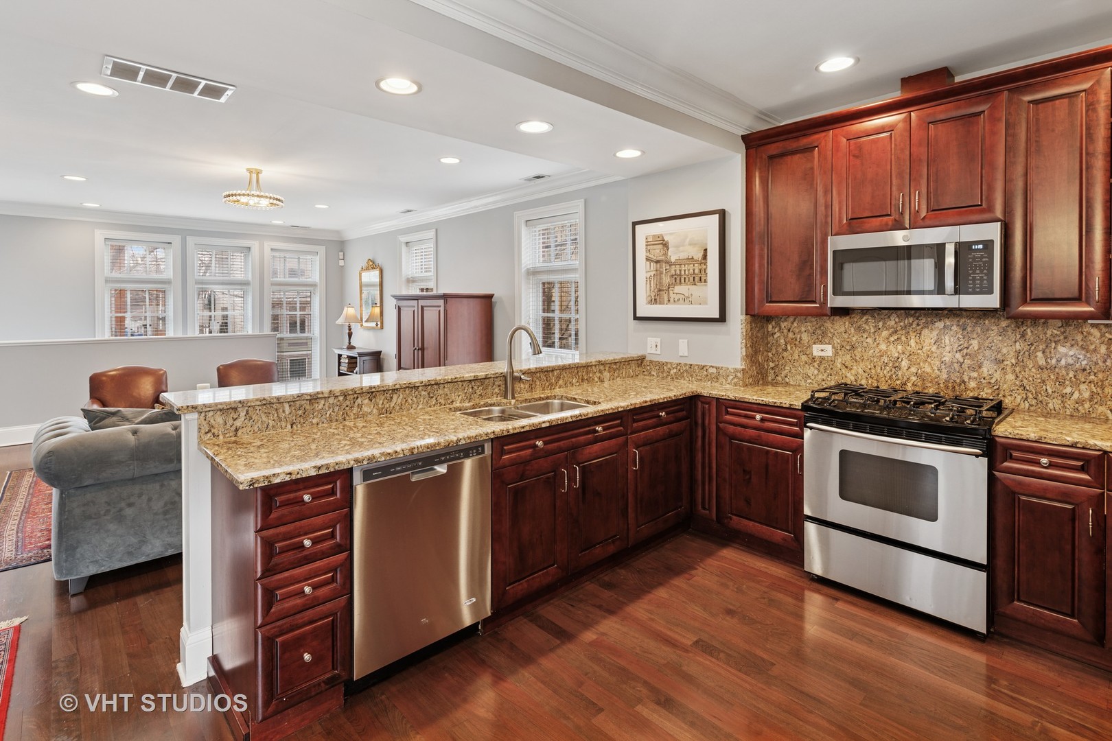 1608 West Grace Street Chicago, IL 60613 - Photo 7 of 25 a kitchen with stainless steel appliances granite countertop a stove and a sink