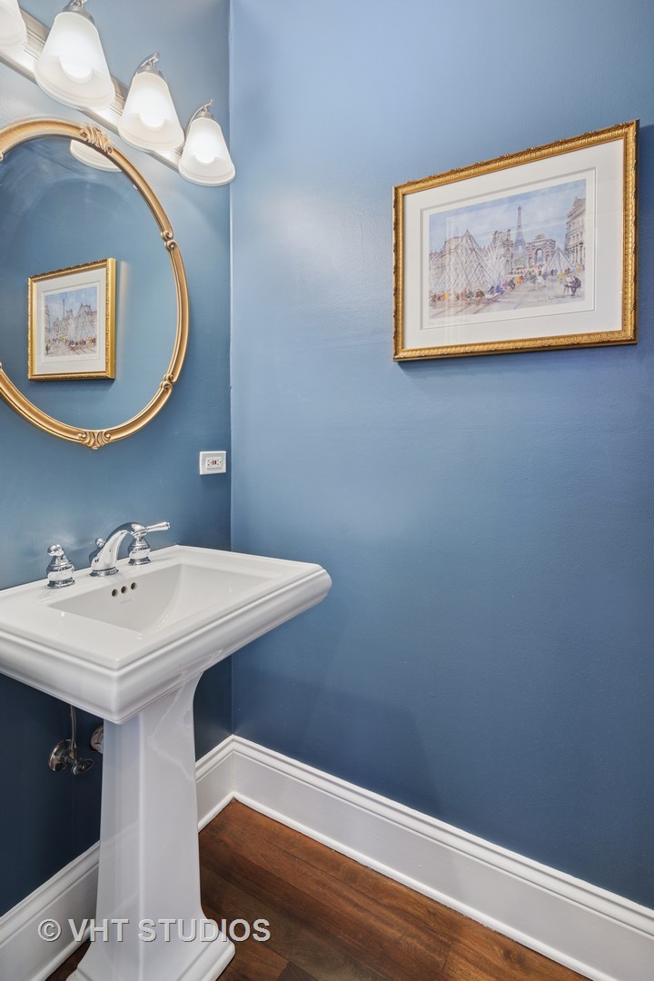 1608 West Grace Street Chicago, IL 60613 - Photo 9 of 25 a bathroom with a sink and a mirror