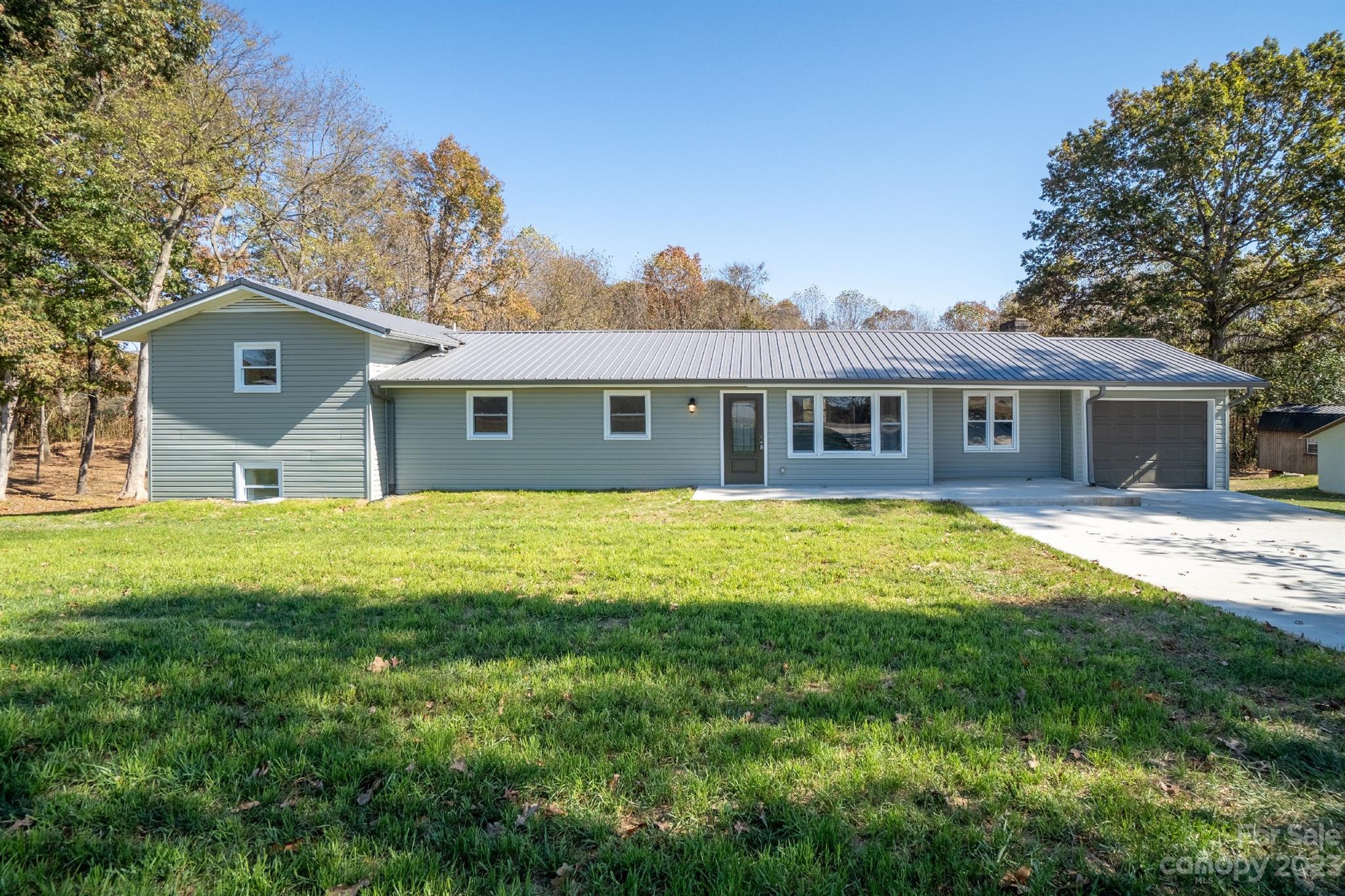 446 Rash Road Olin, NC 28660 - Photo 1 of 35 a front view of a house with a yard and trees