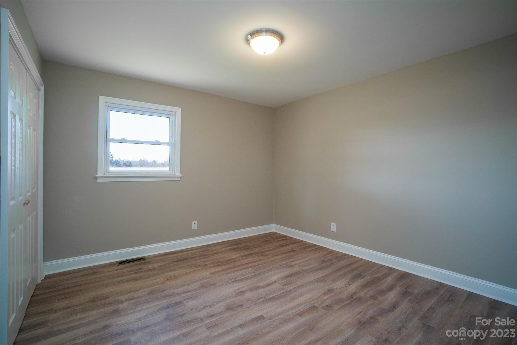 446 Rash Road Olin, NC 28660 - Photo 24 of 35 wooden floor in an empty room with a window