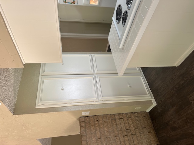 1001 Ridgeline Drive Round Rock, TX 78664 - Photo 5 of 11 Kitchen featuring tile counters, dark wood-type flooring, a textured wall, stovetop, and a textured ceiling
