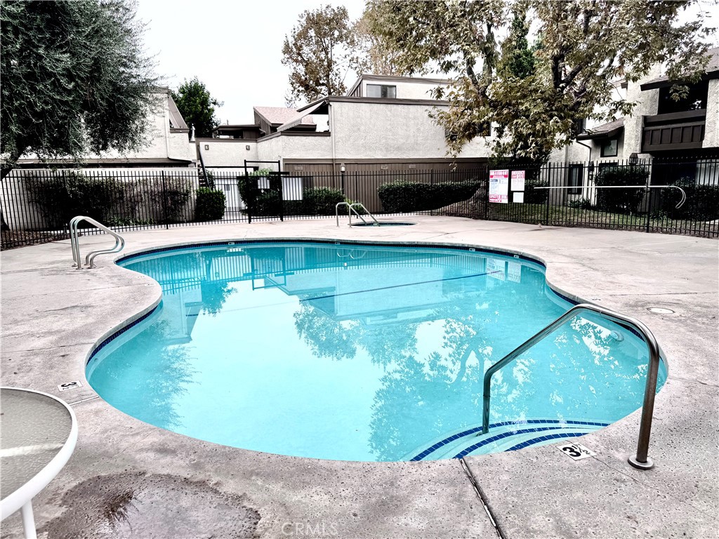 16255 Devonshire Street, Unit 7 Granada Hills, CA 91344 - Photo 16 of 16 a view of a swimming pool with a patio