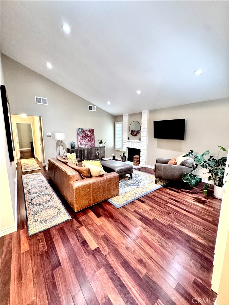 16255 Devonshire Street, Unit 7 Granada Hills, CA 91344 - Photo 2 of 16 a living room with furniture and a flat screen tv