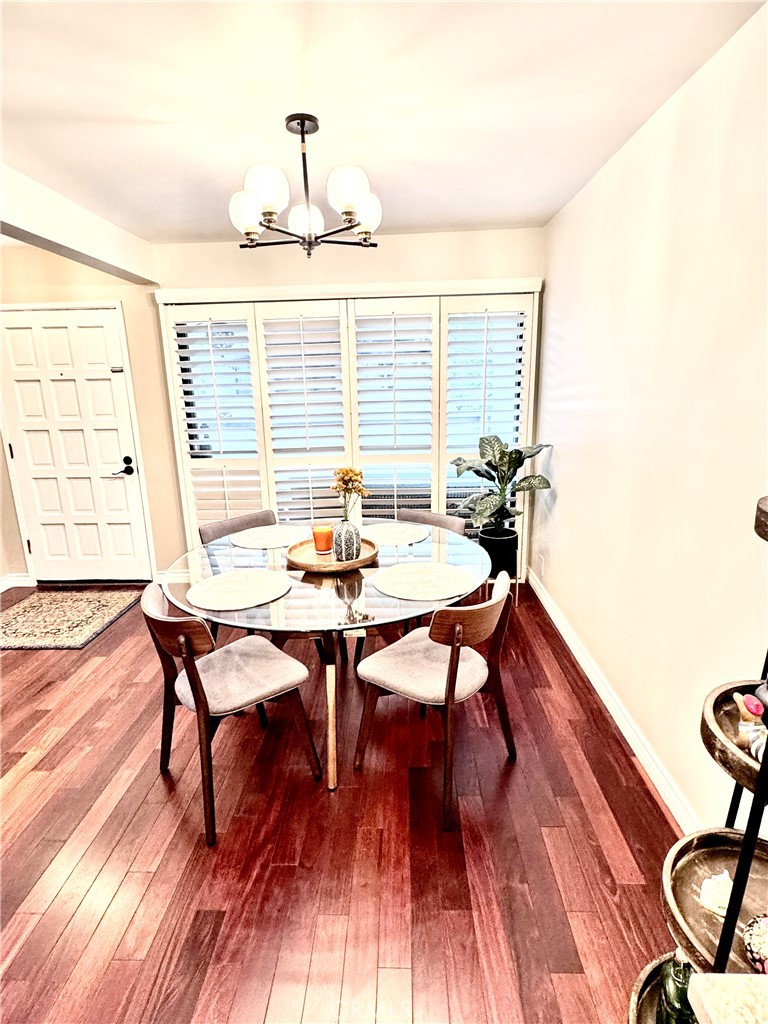 16255 Devonshire Street, Unit 7 Granada Hills, CA 91344 - Photo 5 of 16 a dining room with furniture and wooden floor