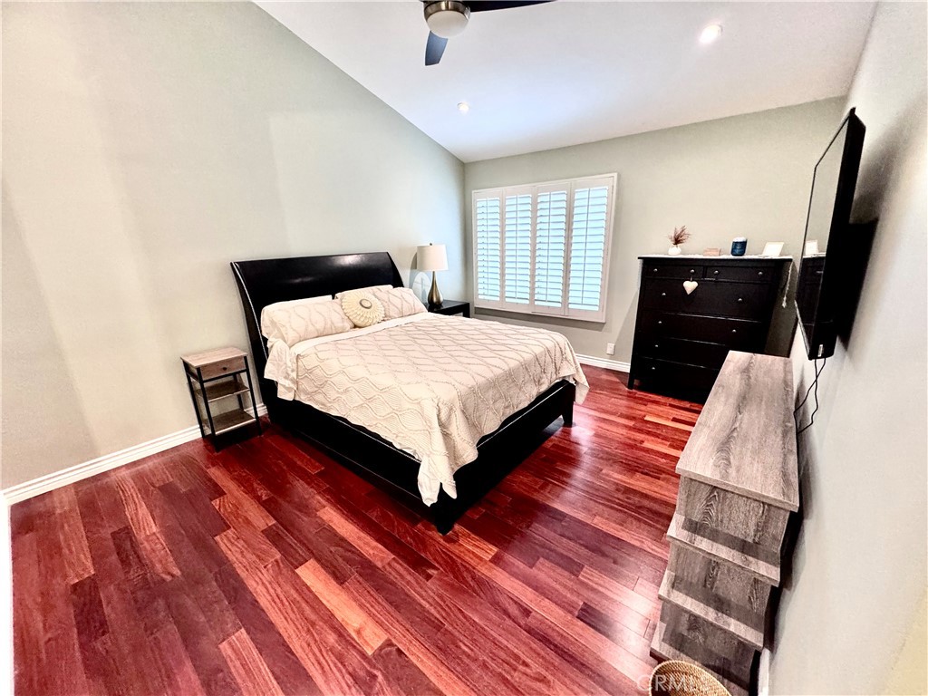 16255 Devonshire Street, Unit 7 Granada Hills, CA 91344 - Photo 8 of 16 a spacious bedroom with a bed and a flat screen tv