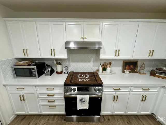 a kitchen with stainless steel appliances a refrigerator a stove and a sink
