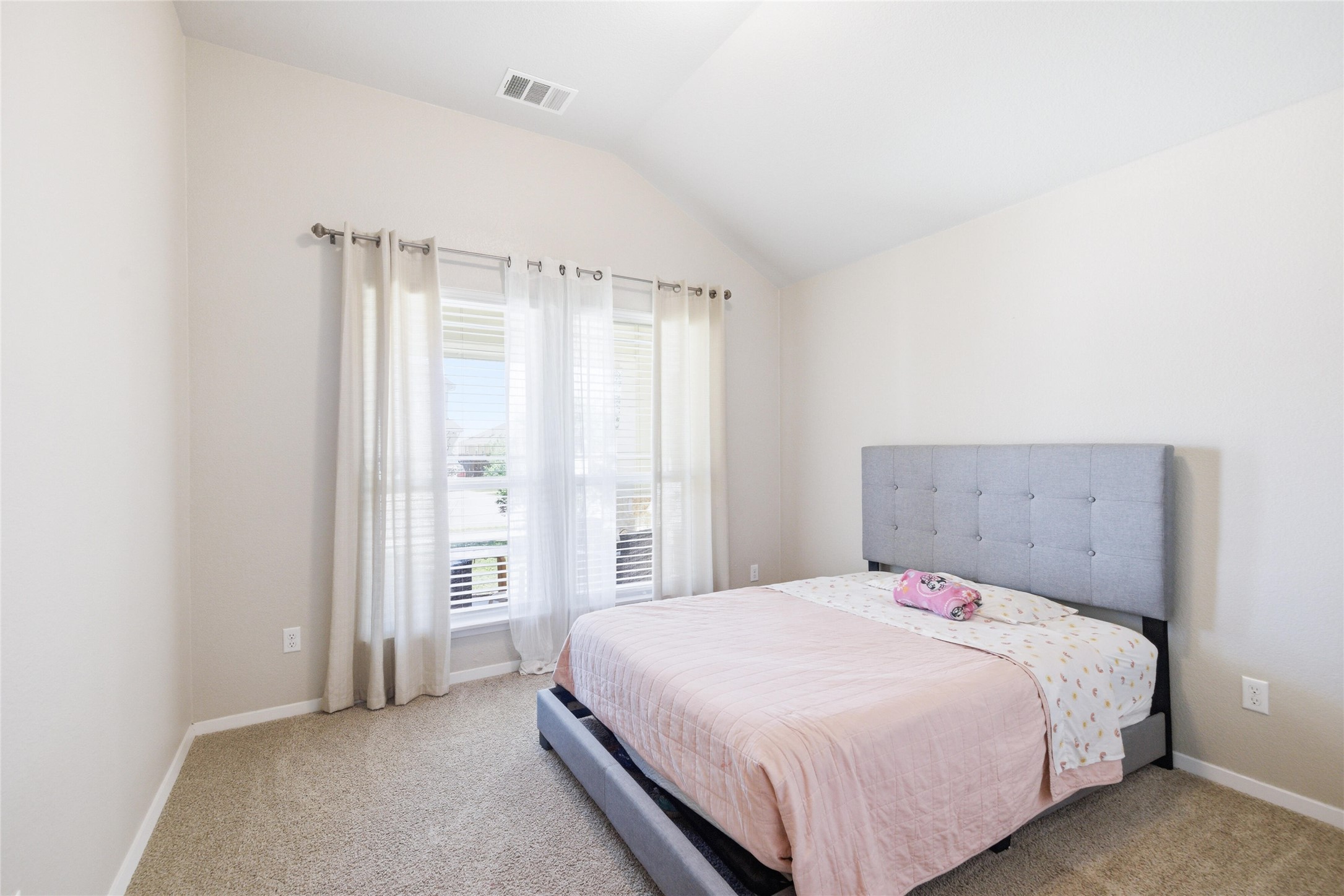269 Gaida Loop Georgetown, TX 78628 - Photo 14 of 20 Bedroom with vaulted ceiling and light colored carpet