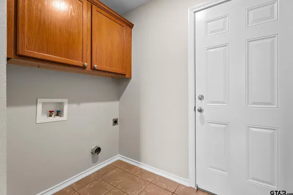 a view of a storage & utility room with cabinet