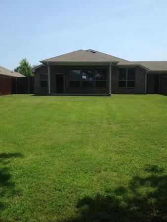 a view of a house with a yard and a fountain