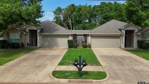 a house view with a garden and trees