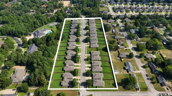 an aerial view of multi story residential apartment building with yard