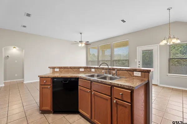 a kitchen with a sink and a wooden cabinets