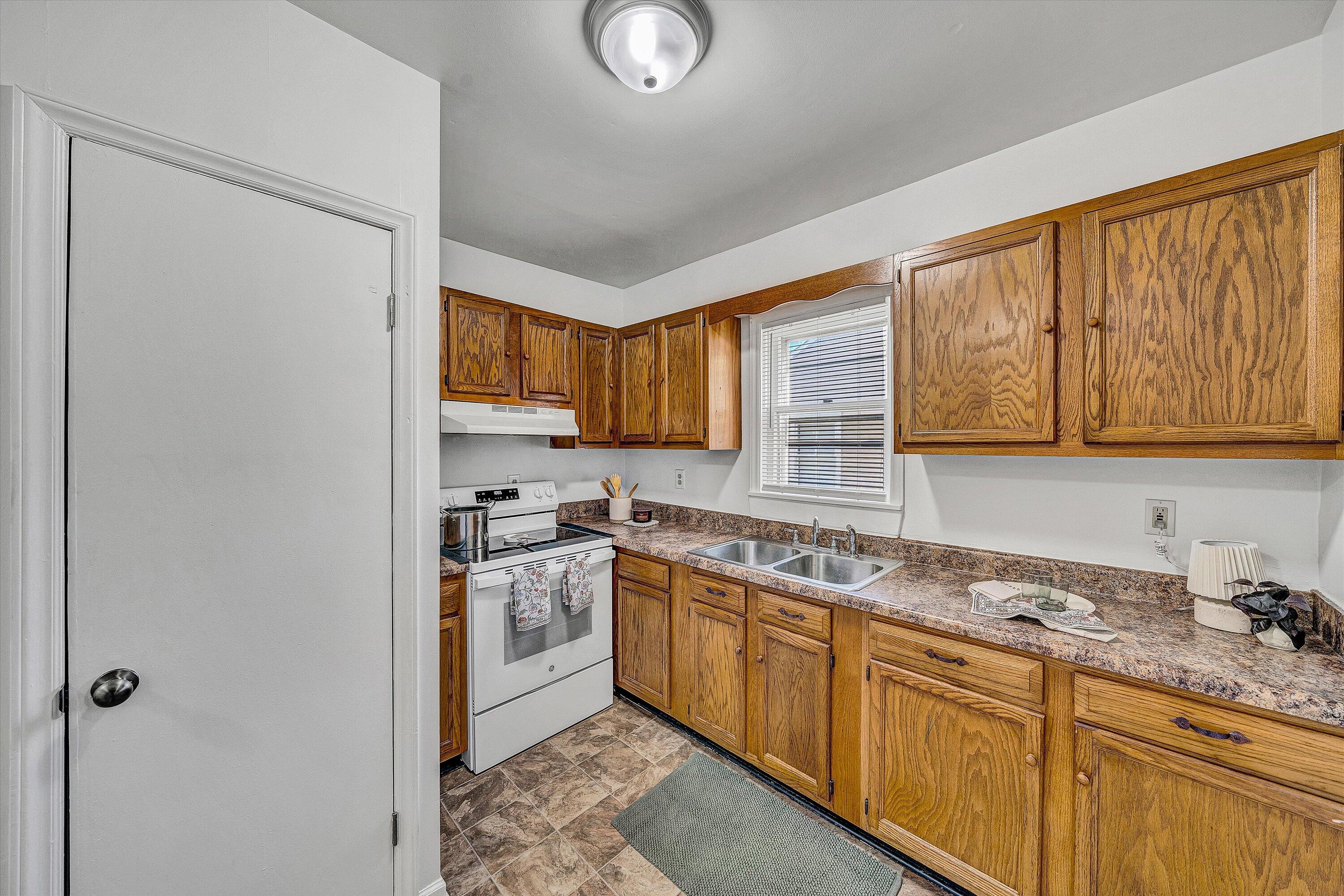 115 Liberty Road Northeast Roanoke, VA 24012 - Photo 11 of 24 a kitchen with stainless steel appliances granite countertop a sink stove and refrigerator