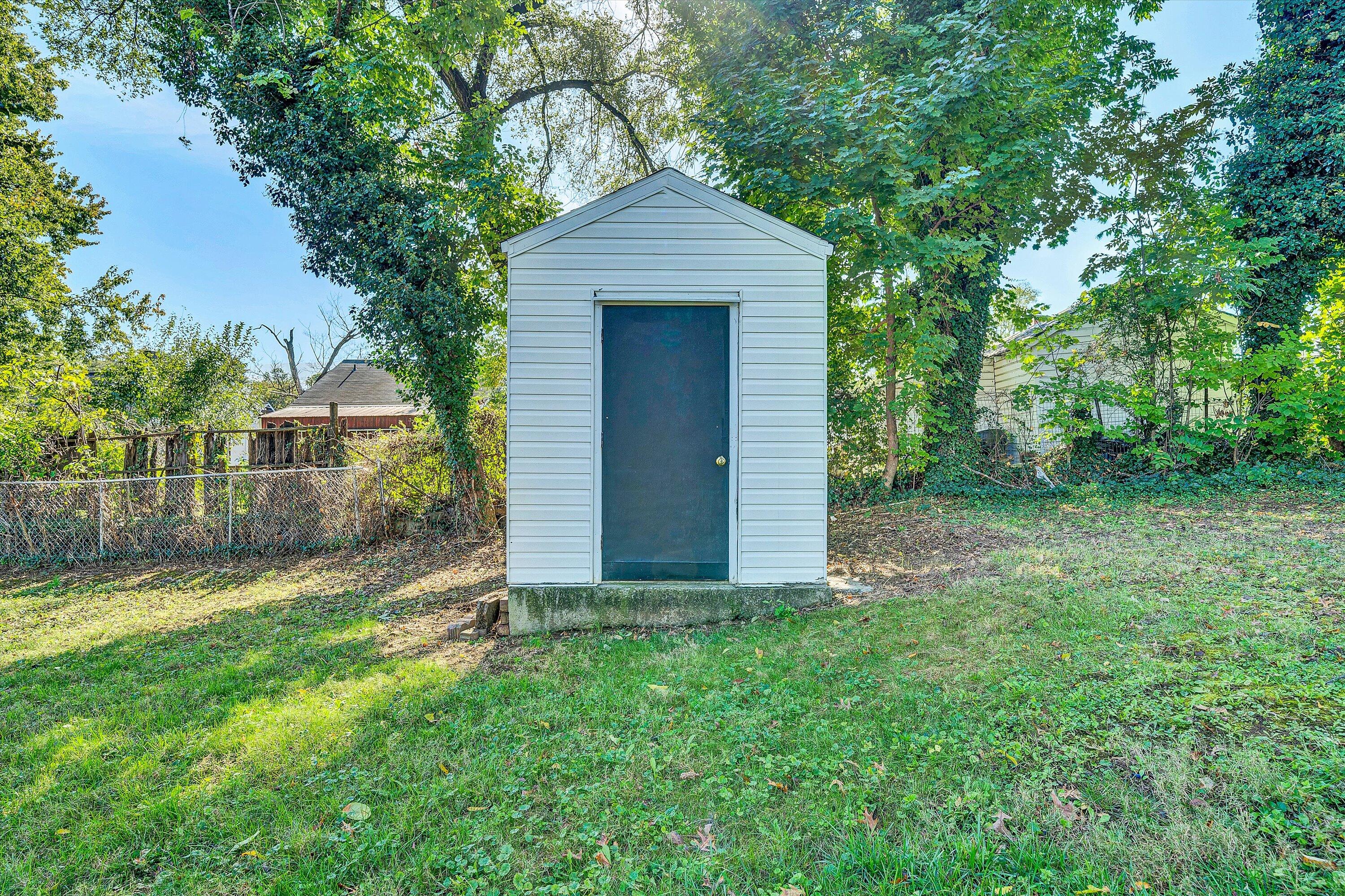 115 Liberty Road Northeast Roanoke, VA 24012 - Photo 22 of 24 a front view of a house with a yard and trees