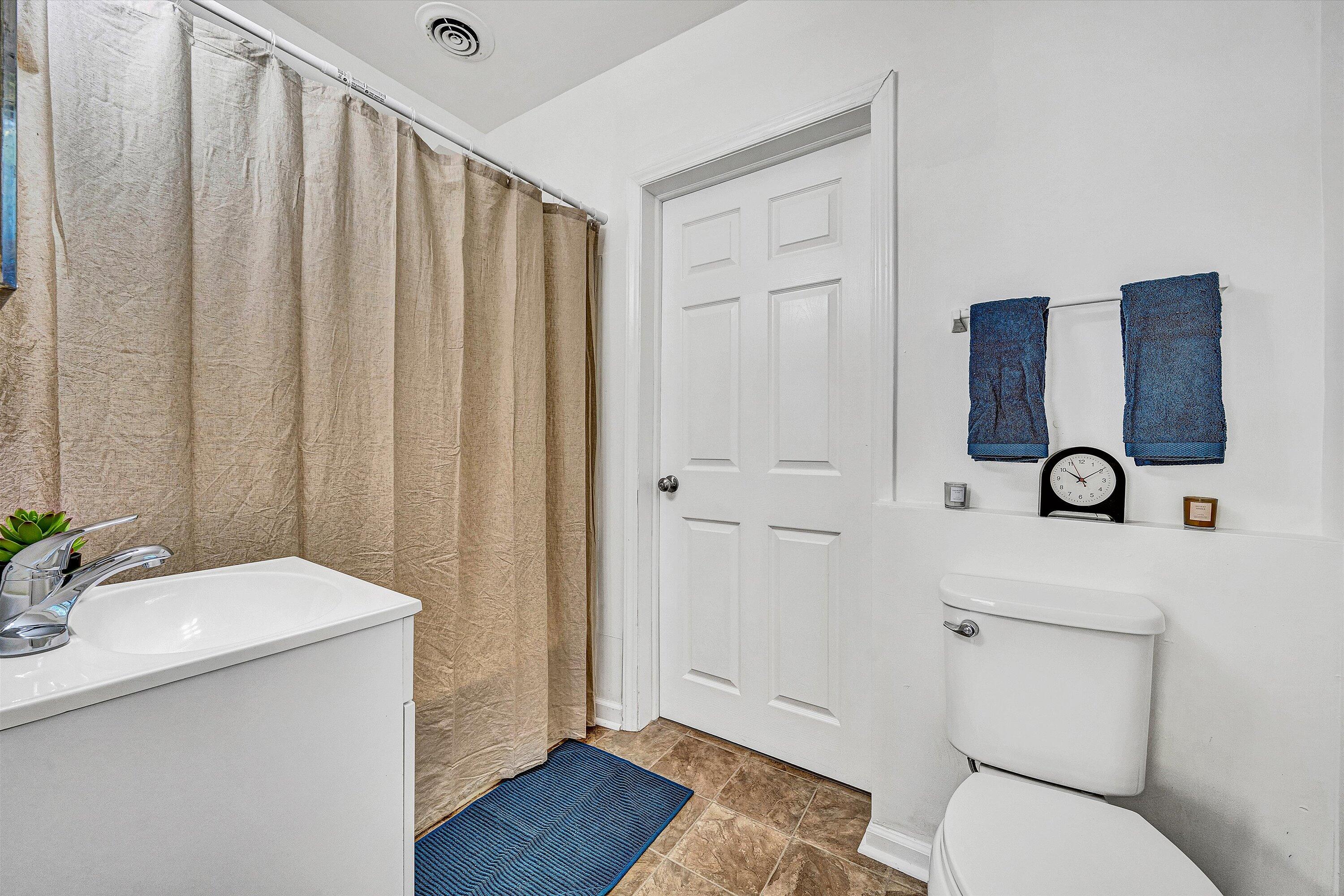 115 Liberty Road Northeast Roanoke, VA 24012 - Photo 8 of 24 a bathroom with a sink toilet and shower
