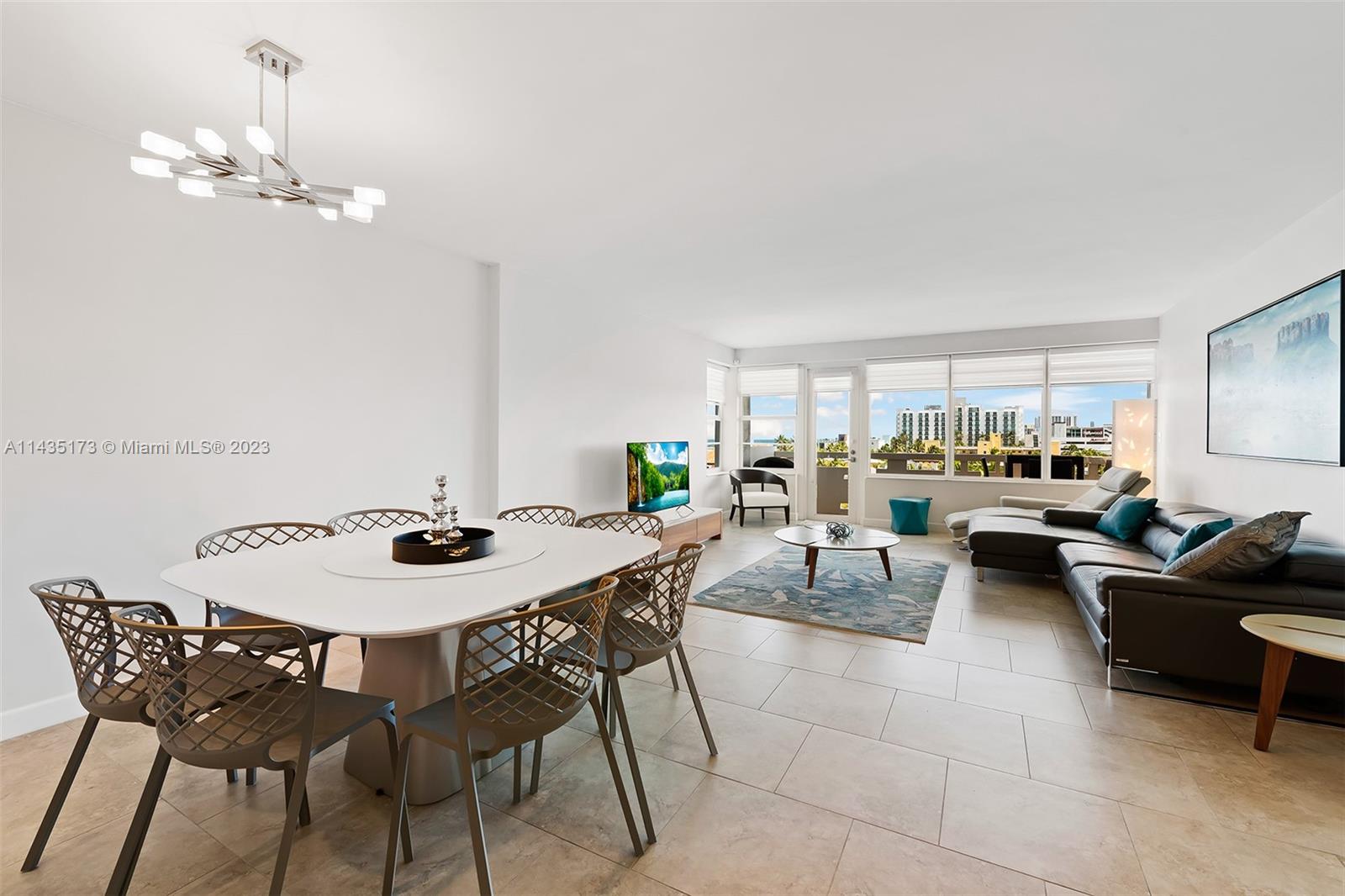 a view of a dining room with furniture and chandelier