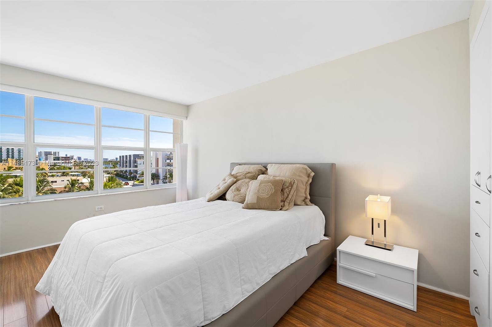 3111 North Ocean Drive, Unit 512 Hollywood, FL 33019 - Photo 15 of 33 a bedroom with a large bed and a window