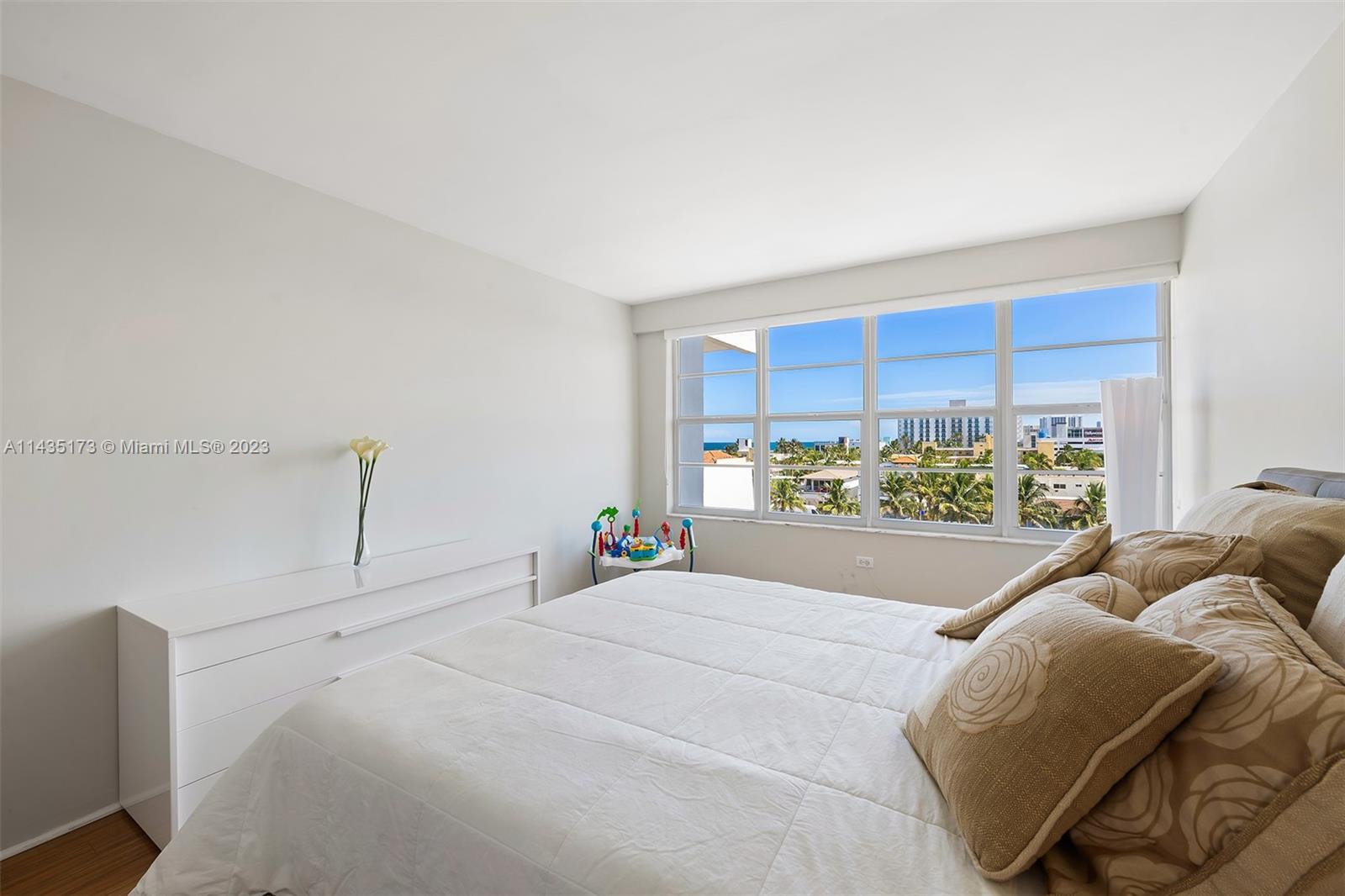 3111 North Ocean Drive, Unit 512 Hollywood, FL 33019 - Photo 16 of 33 a bed sitting in a bedroom next to a window