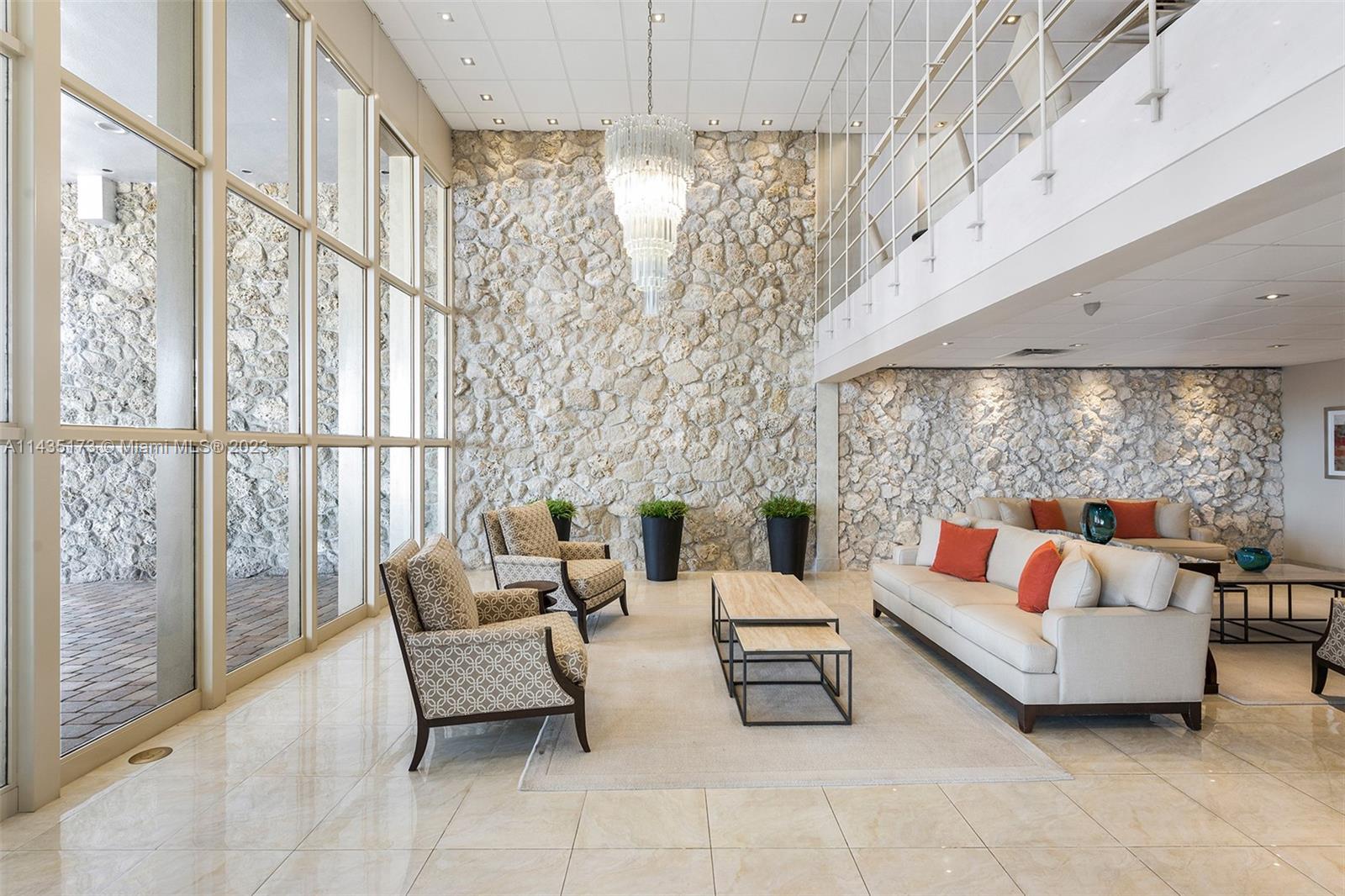 3111 North Ocean Drive, Unit 512 Hollywood, FL 33019 - Photo 27 of 33 a outdoor living room with furniture and a chandelier