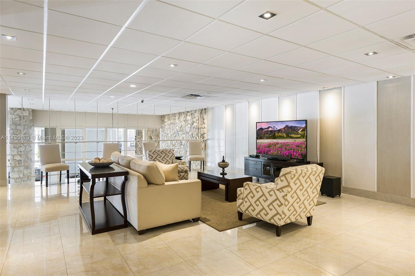 3111 North Ocean Drive, Unit 512 Hollywood, FL 33019 - Photo 28 of 33 a living room with furniture and a flat screen tv