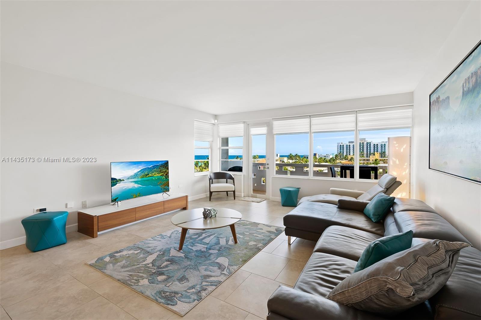 3111 North Ocean Drive, Unit 512 Hollywood, FL 33019 - Photo 3 of 33 a living room with furniture and a flat screen tv