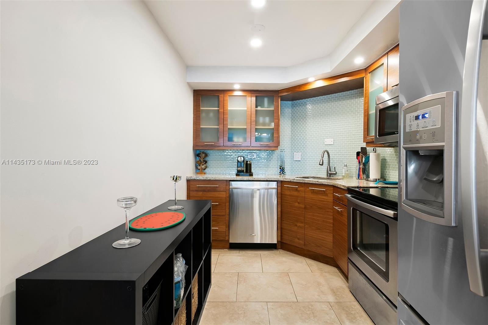 3111 North Ocean Drive, Unit 512 Hollywood, FL 33019 - Photo 7 of 33 a kitchen with a sink stove and microwave