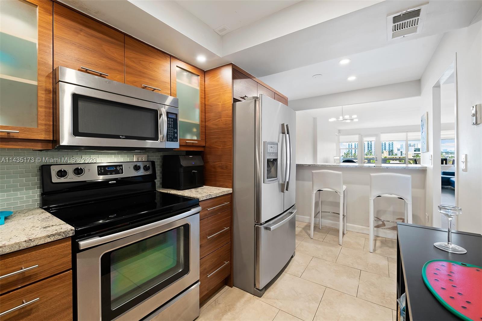 3111 North Ocean Drive, Unit 512 Hollywood, FL 33019 - Photo 8 of 33 a kitchen with a stove a microwave and a refrigerator