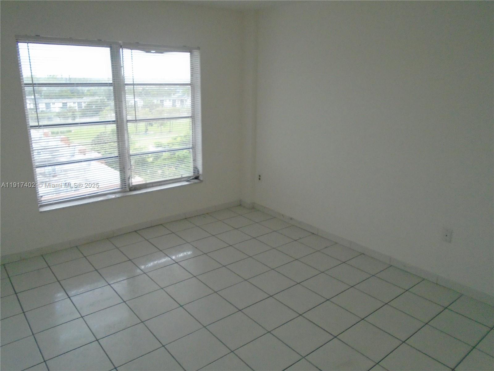 4174 Inverrary Drive, Unit 1004 Lauderhill, FL 33319 - Photo 15 of 53 an empty room with windows