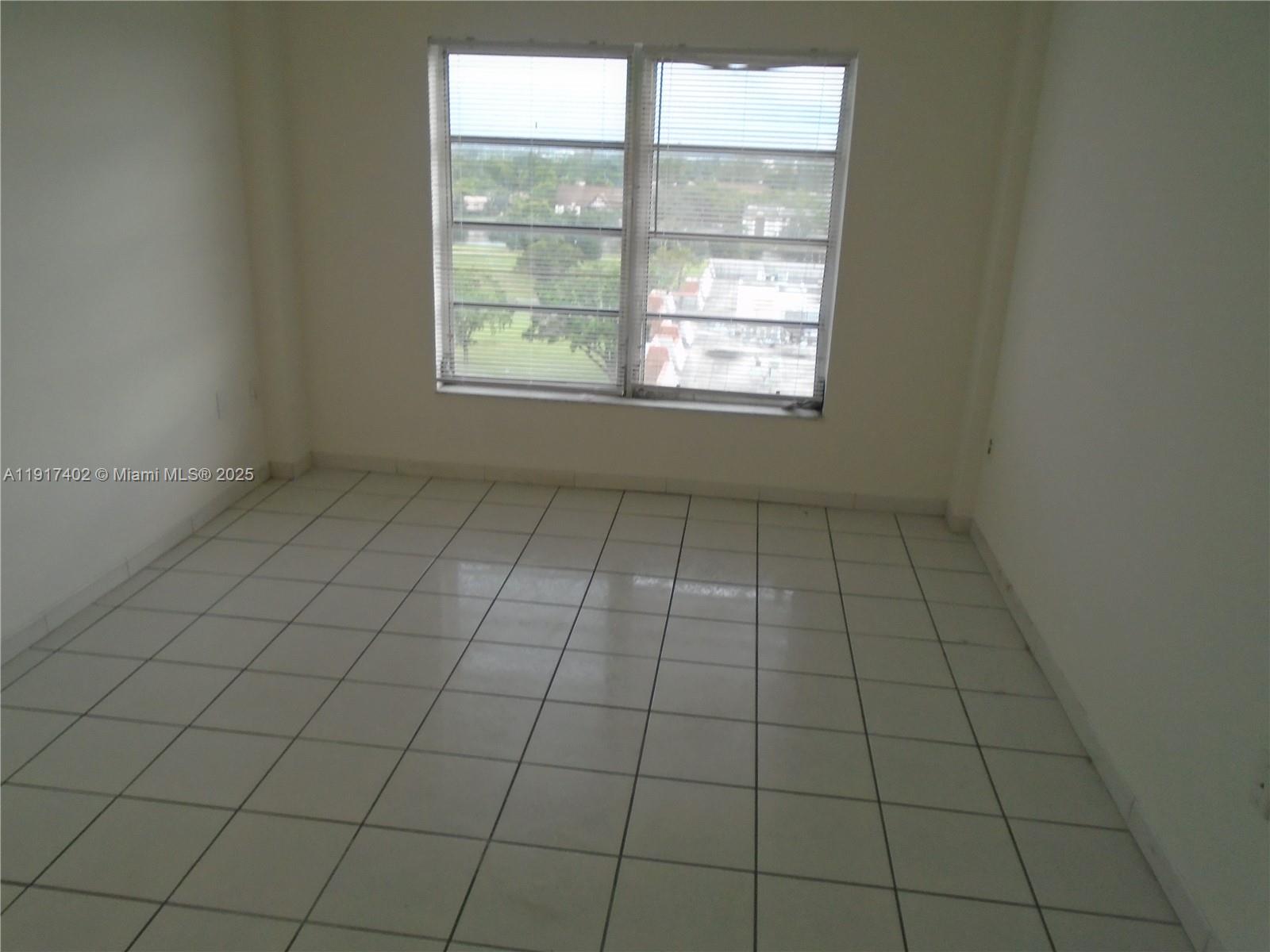 4174 Inverrary Drive, Unit 1004 Lauderhill, FL 33319 - Photo 16 of 53 an empty room with windows
