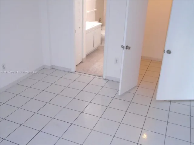 a view of an empty room and bathroom