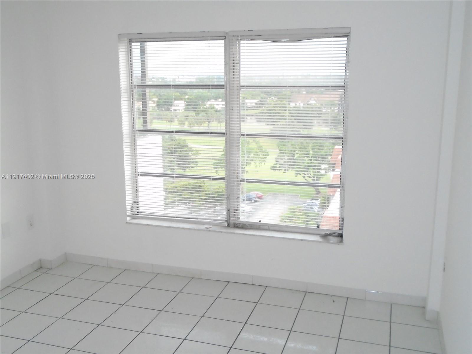 4174 Inverrary Drive, Unit 1004 Lauderhill, FL 33319 - Photo 19 of 53 a view of an empty room with a window