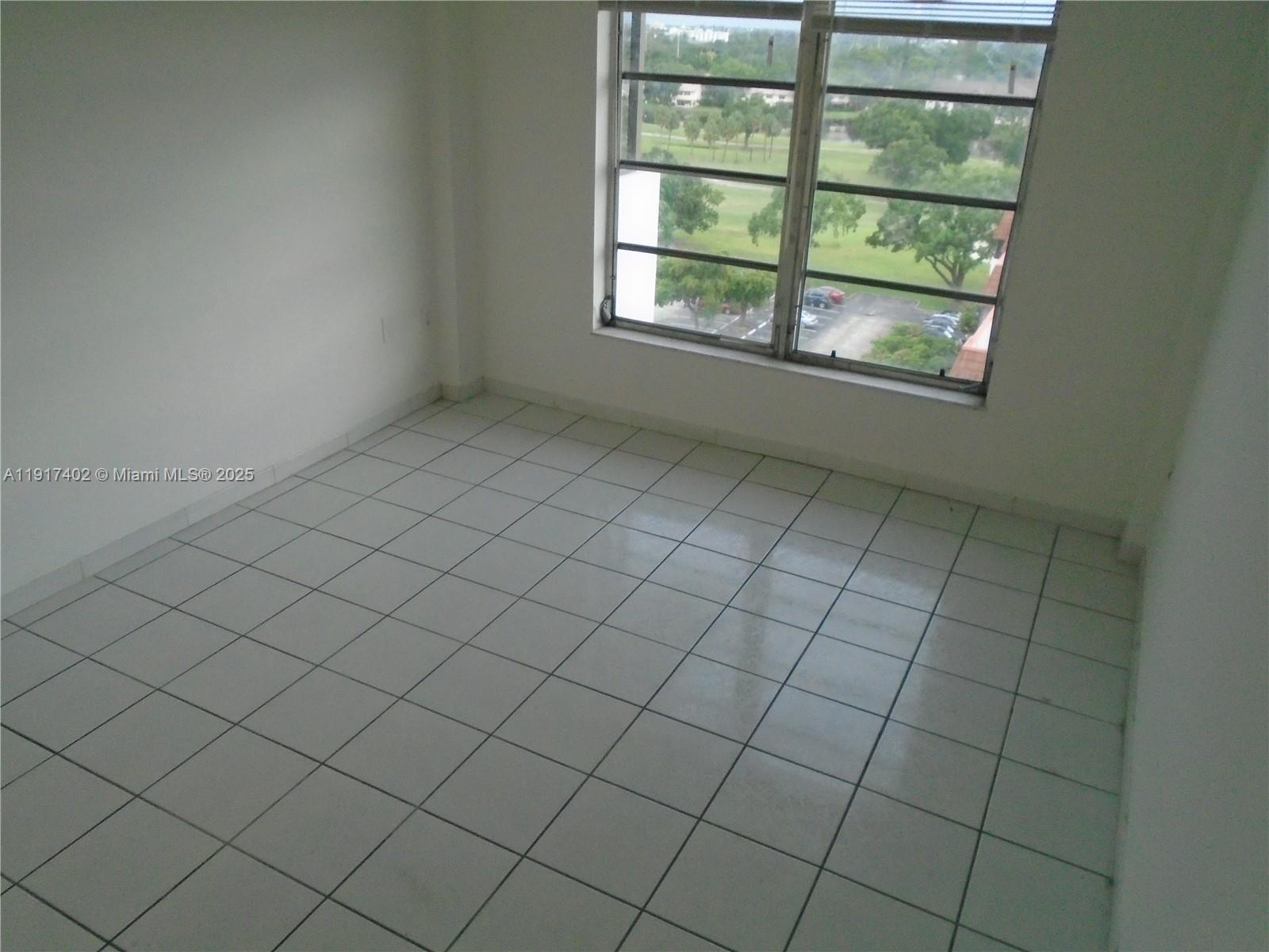 4174 Inverrary Drive, Unit 1004 Lauderhill, FL 33319 - Photo 20 of 53 an empty room with windows