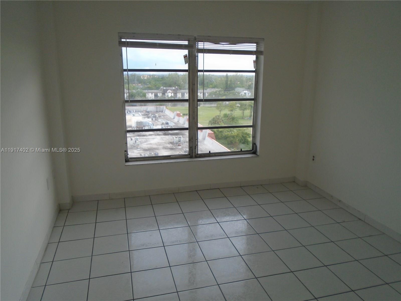4174 Inverrary Drive, Unit 1004 Lauderhill, FL 33319 - Photo 21 of 53 an empty room with windows