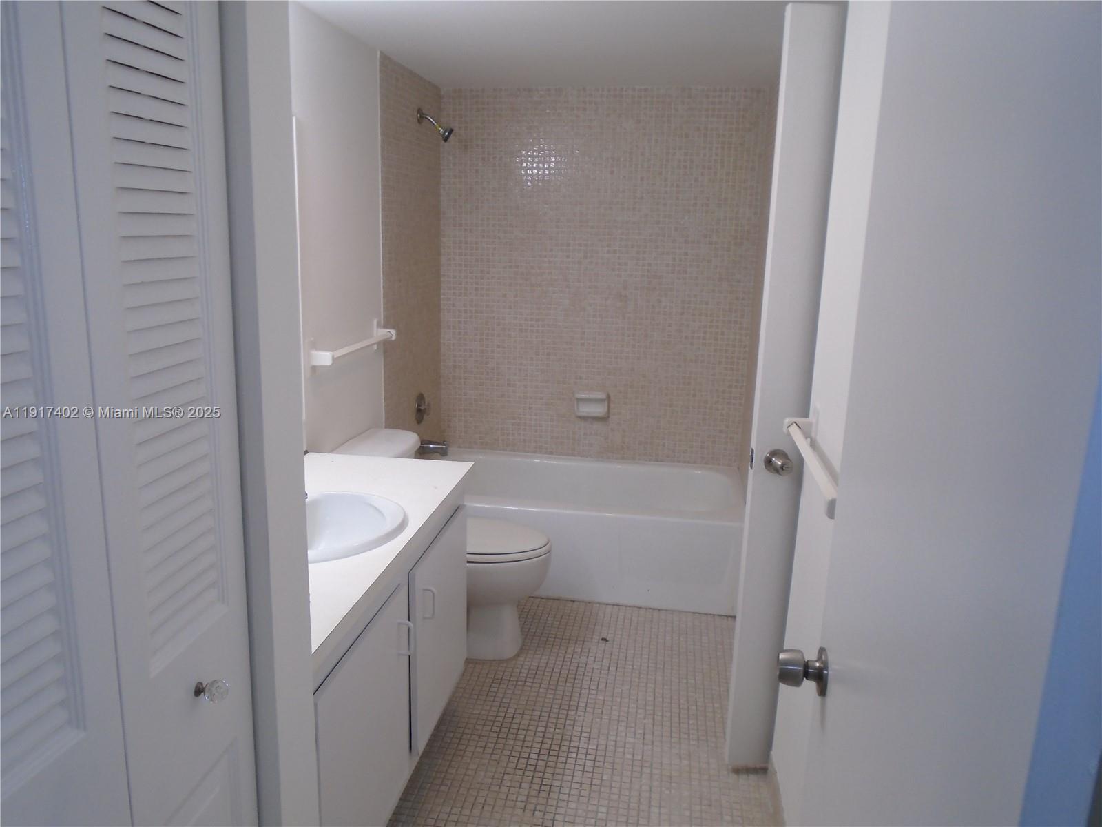 4174 Inverrary Drive, Unit 1004 Lauderhill, FL 33319 - Photo 23 of 53 a bathroom with a toilet a sink and bathtub