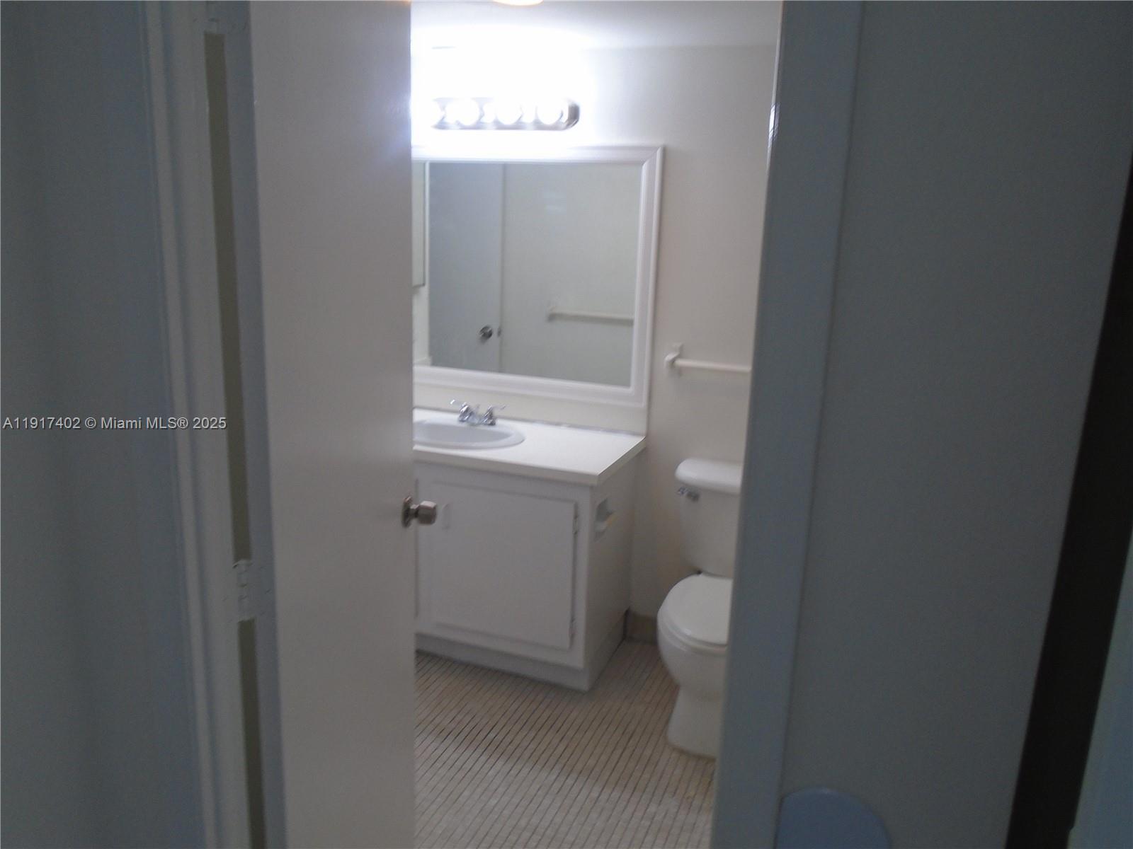 4174 Inverrary Drive, Unit 1004 Lauderhill, FL 33319 - Photo 24 of 53 a bathroom with a sink toilet and vanity