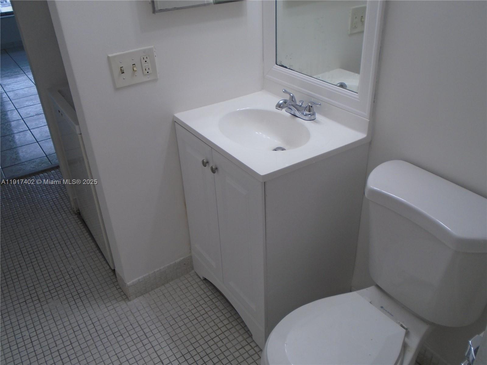 4174 Inverrary Drive, Unit 1004 Lauderhill, FL 33319 - Photo 37 of 53 a bathroom with a toilet sink and mirror