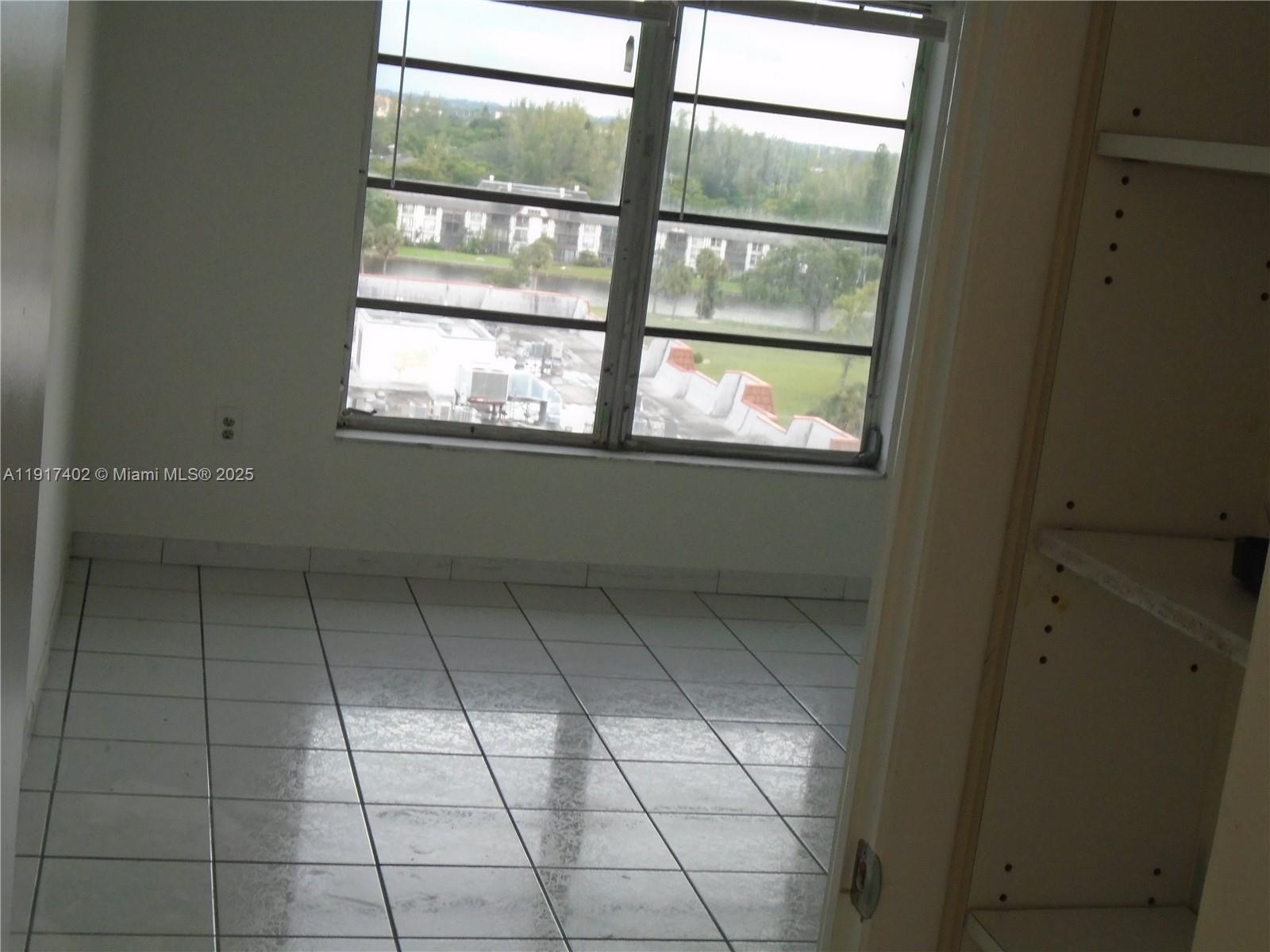 4174 Inverrary Drive, Unit 1004 Lauderhill, FL 33319 - Photo 40 of 53 a view of an empty room with a window