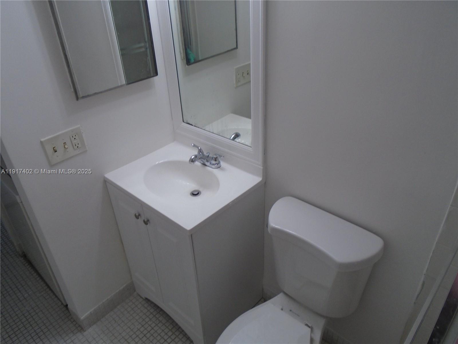 4174 Inverrary Drive, Unit 1004 Lauderhill, FL 33319 - Photo 41 of 53 a white toilet sitting next to a bathroom sink