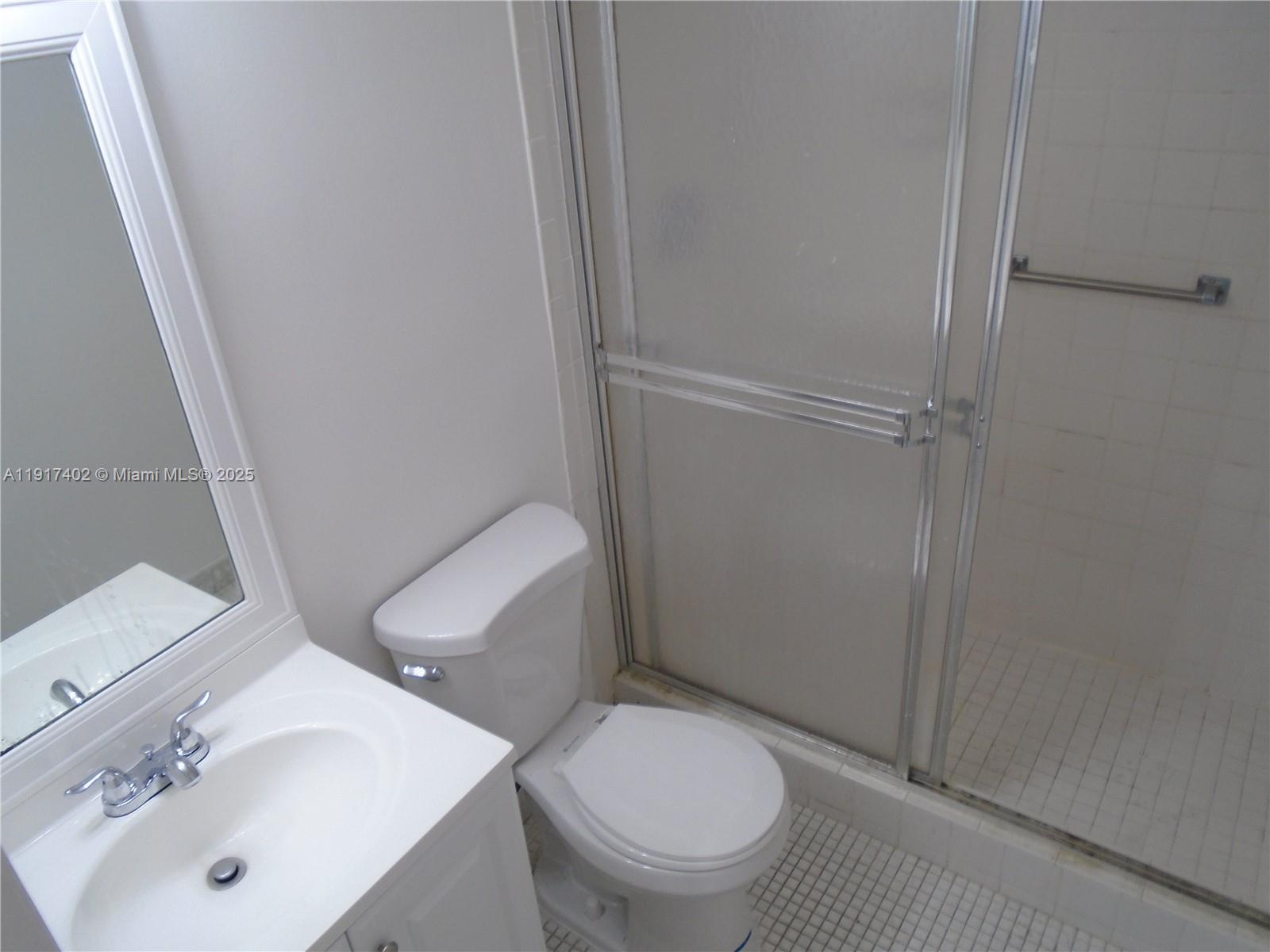 4174 Inverrary Drive, Unit 1004 Lauderhill, FL 33319 - Photo 42 of 53 a white toilet sitting next to a bathroom sink