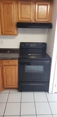 a view of a kitchen with microwave and cabinets