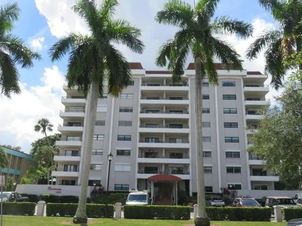 a view of a tall building with a palm tree