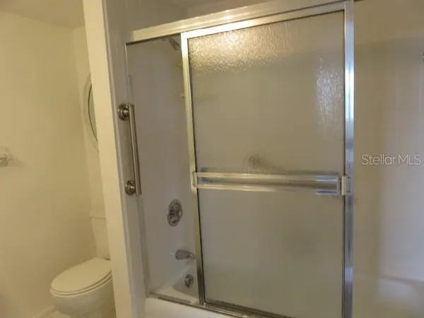 a bathroom with a glass shower door