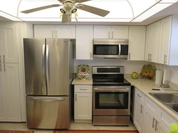 a kitchen with a refrigerator stove and microwave