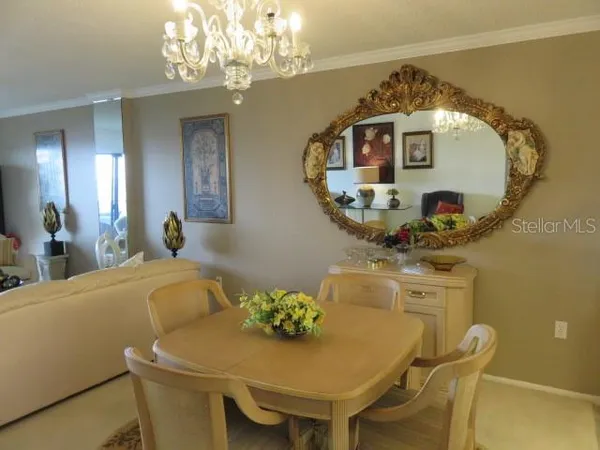 a dining room with furniture and chandelier