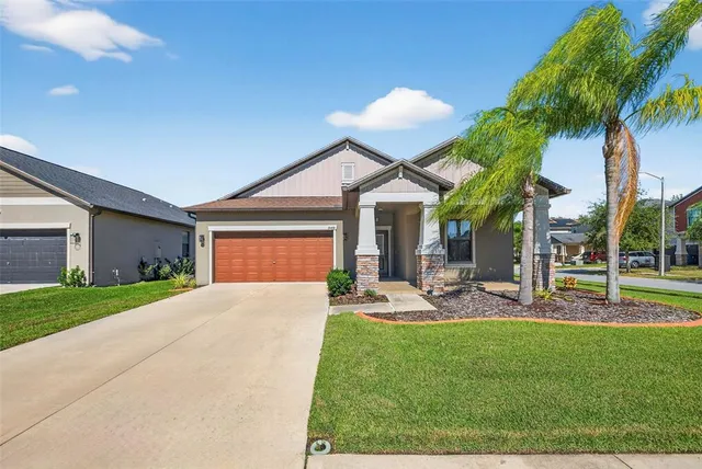 a view of a house with backyard porch and sitting area