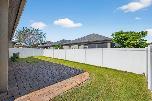 a view of a backyard with a garden and yard