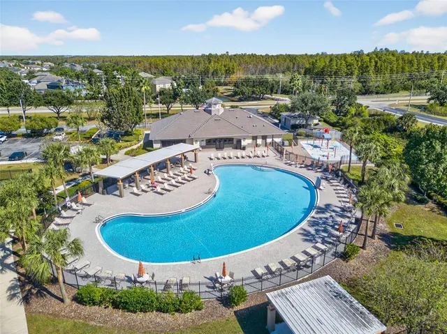 an aerial view of a house with a swimming pool yard and outdoor seating