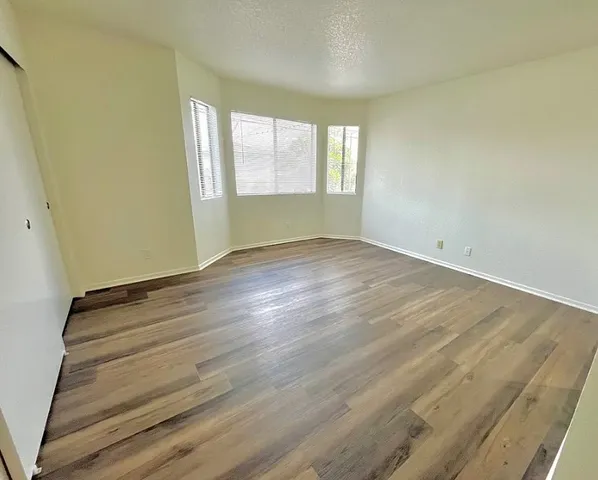 a room with a bed and wooden floor